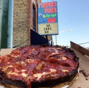 Sign outside Pequod's Pizza restaurant in Chicago says, "Go Cubs Go"
