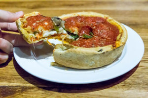A plate of personal size deep dish pizza in Chicago