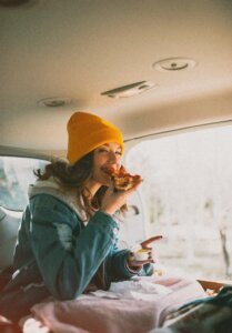 Woman eating and enjoying pizza