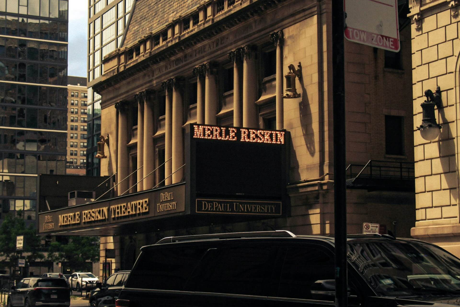 Merle reskin theatre building with depaul university sign and cars